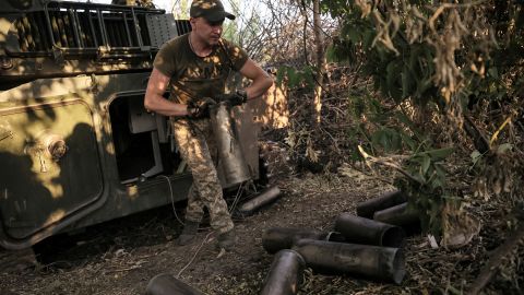 A Ukrainian serviceman removes empty shell cartridges after firing towards Russian troops on the front line near Chasiv Yar on June 30, 2024.