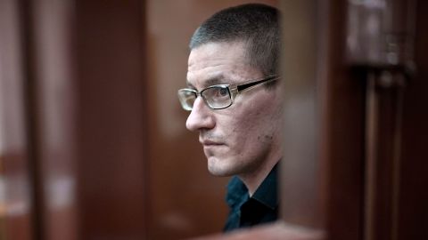 Robert Woodland, a Russia-born U.S. citizen, stands in a glass cage during a court hearing, Thursday, July 4, 2024, in Moscow, Russia. Woodland was convicted of drug-related charges and sentenced to 12 and a 1/2 years in prison on Thursday. (AP Photo/Alexander Zemlianichenko)